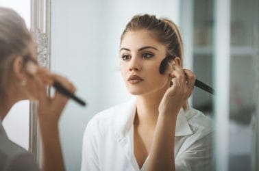 vrouw met het huidprobleem rosacea heeft make-up aangebracht