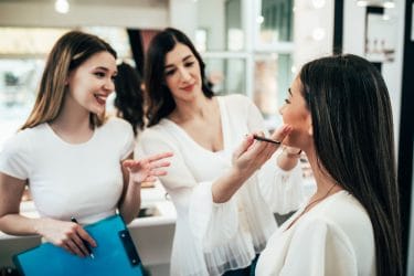 Docente van beauty opleiding helpt studente op weg tijdens praktijkles